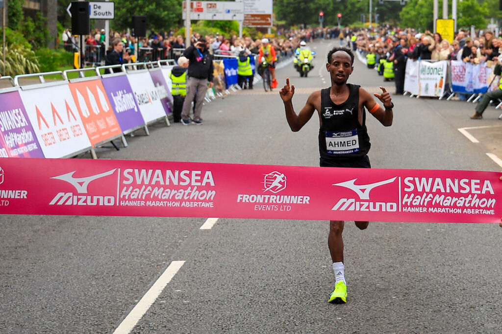 Male Winner: Omar Ahmed breaking the tape at the Mizuno Swansea Half Marathon 2026, Swansea, Wales, 7 June 2026.